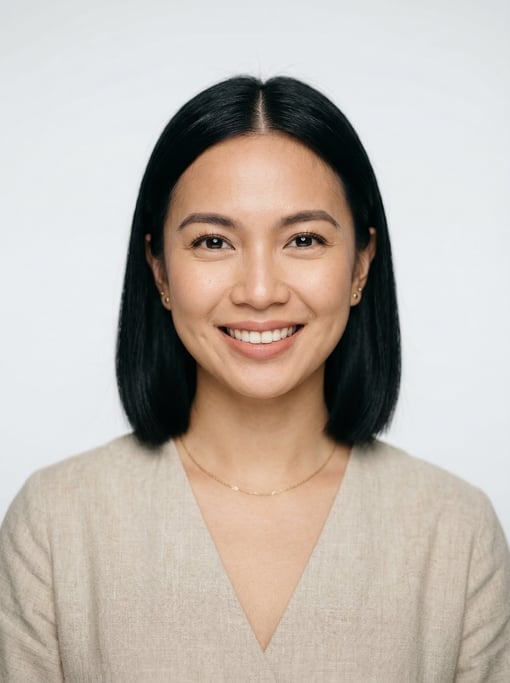 Professional studio headshot of a 29-year-old Filipino woman with a blunt bob in jet black with a mi