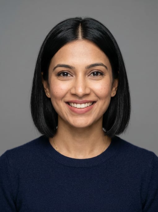 Professional studio headshot of a 30-year-old Indian woman with a blunt bob in jet black with a midd