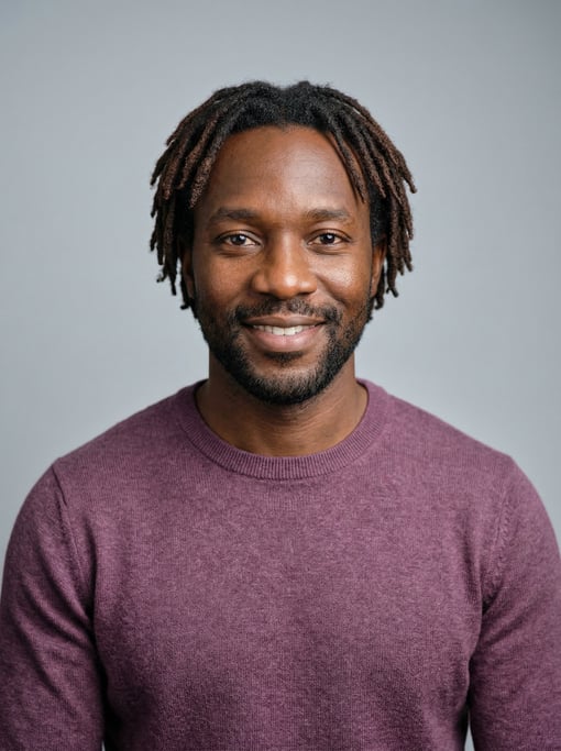 Professional studio headshot of a 38-year-old West African man with short locs in dark brown