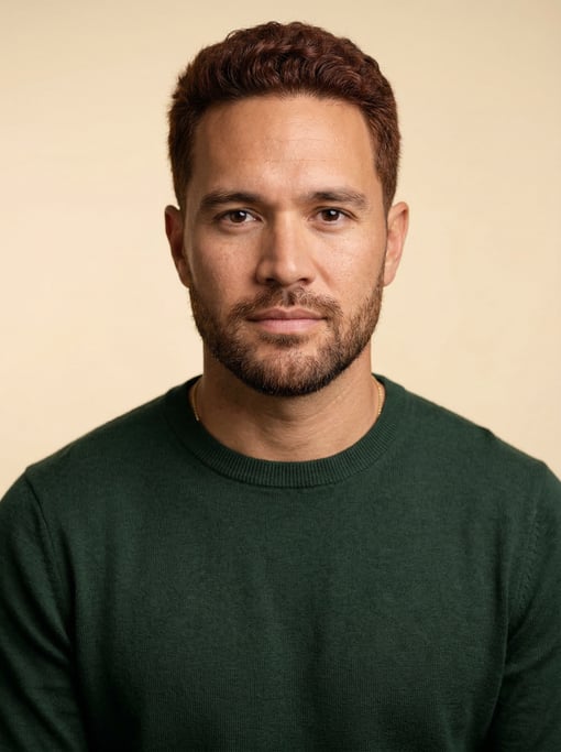Professional studio headshot of a 35-year-old Hawaiian man with short auburn hair