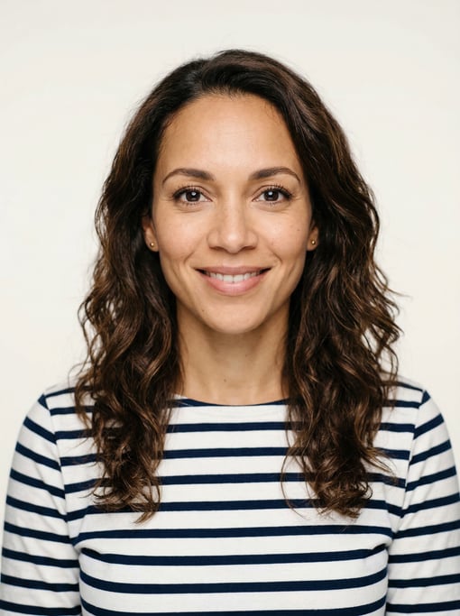 Professional studio headshot of a 38-year-old mixed-race woman with long wavy dark brown hair