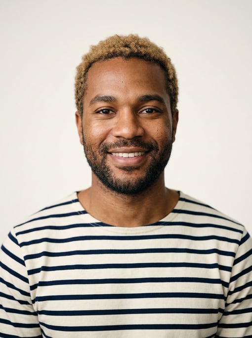 Professional studio headshot of a 28-year-old Black African man with short dirty blonde hair