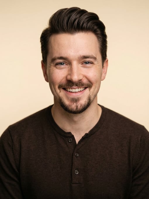Professional studio headshot of a 26-year-old White British man with a pompadour in dark brown