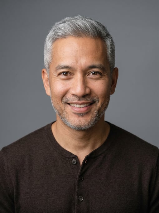 Professional studio headshot of a 38-year-old Southeast Asian man with fully grey short cropped hair