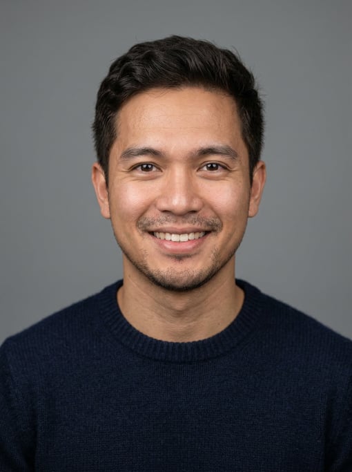 Professional studio headshot of a 29-year-old Filipino man with short textured dark brown hair
