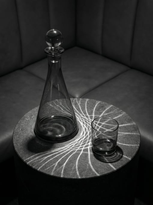 Smoke grey glass tapering from wide base to narrow neck