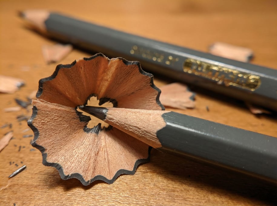 Extreme close-up of a pencil sharpening showing the fresh wood exposed in a spiral of shaving
