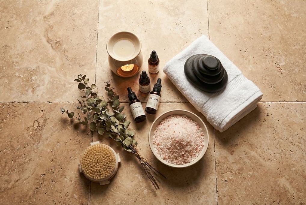 Warm travertine tile becomes the spa surface: ceramic oil burner