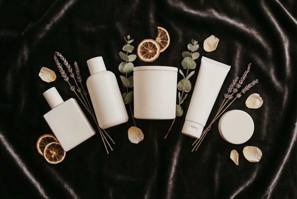 Five scent products in matching minimal white vessels — parfum