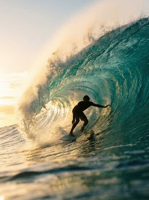 Surfer dropping into a large wave, shot from the water level