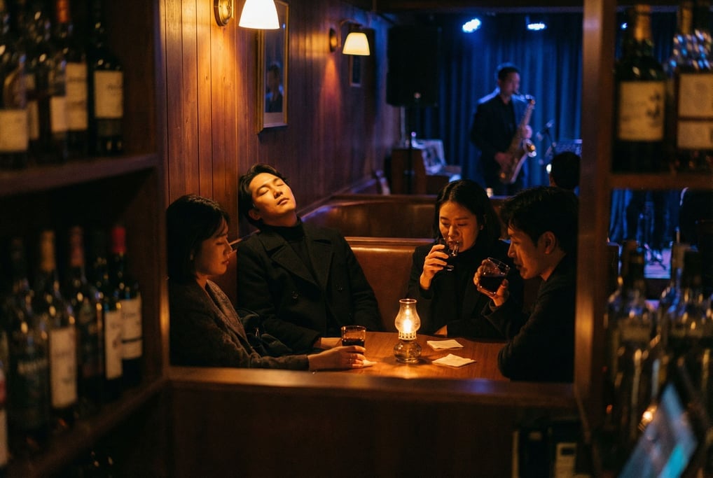 Four friends at a corner booth in a dim jazz bar