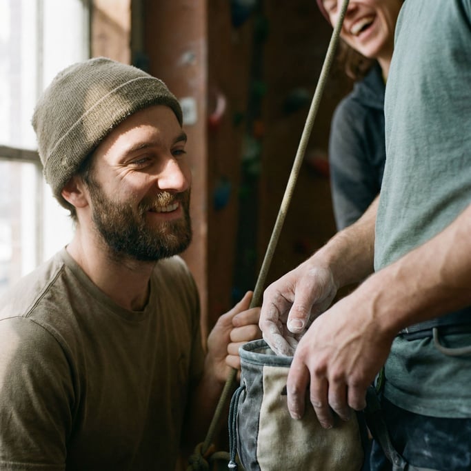 A climber chalking their hands before a route, close-up on the texture of chalk and skin (eif3twe)