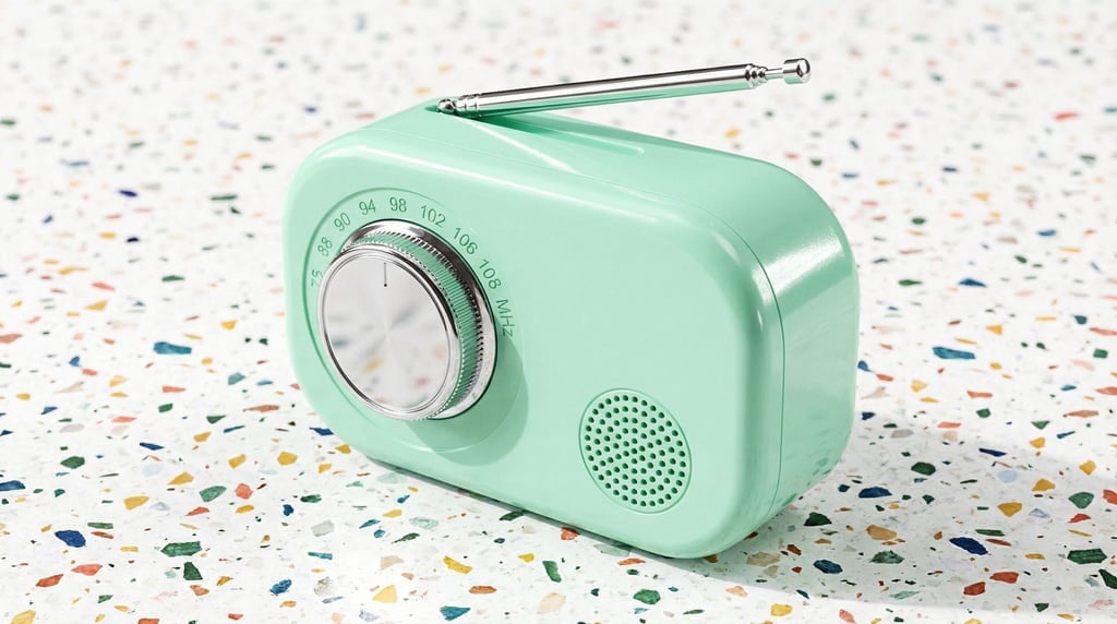 Engraved frequency numbers ring the chrome tuning dial of a concept pocket FM radio in pastel mint green
