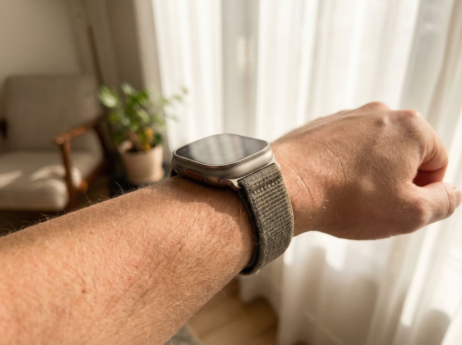 A smartwatch on a bare wrist, natural light, skin texture visible, intimate and personal (lv3pztoi)