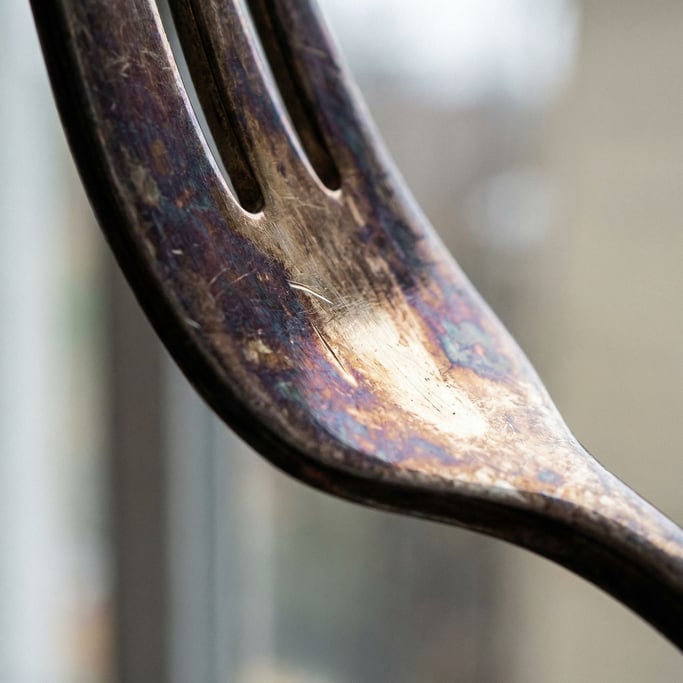 Extreme close-up of Tarnished silver flatware surface (kze3xtvo)