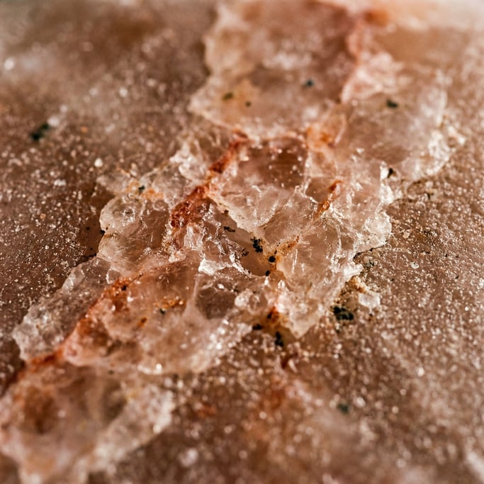A slab of pink Himalayan salt in macro, crystalline structure and mineral inclusions (nc8ugrvm)
