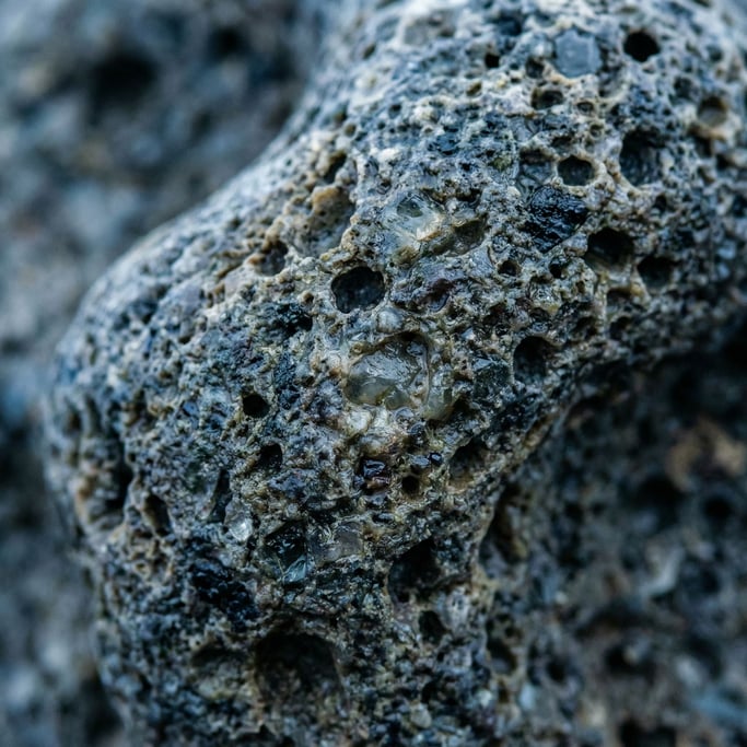 Volcanic pumice stone in macro, air pockets and mineral crystals in the porous surface