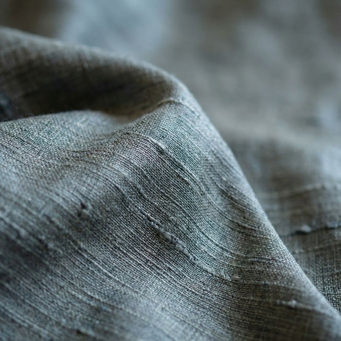 Extreme close-up of Raw silk fabric draped and catching side light (es08occ1)