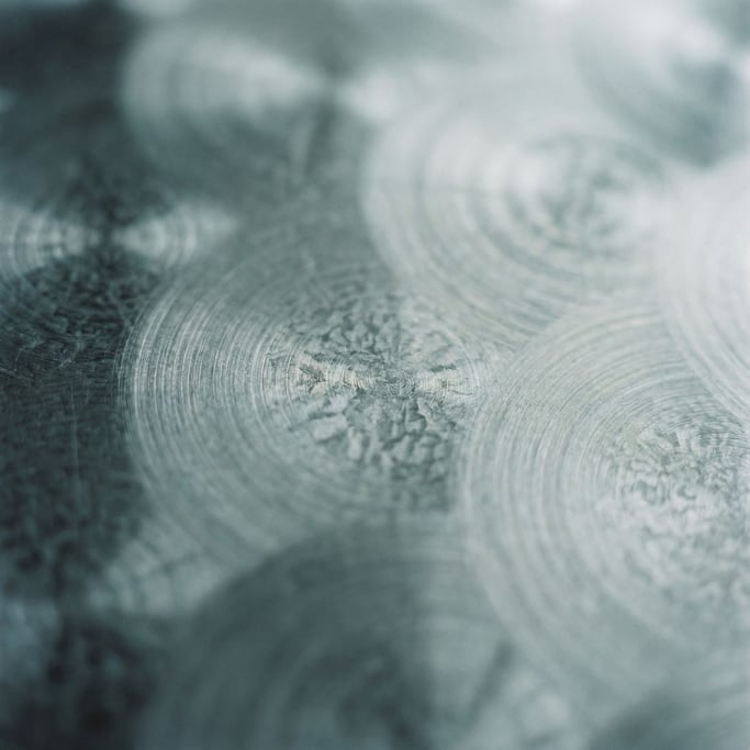 Extreme close-up of Brushed stainless steel with circular polishing marks, cool industrial surface (k8)