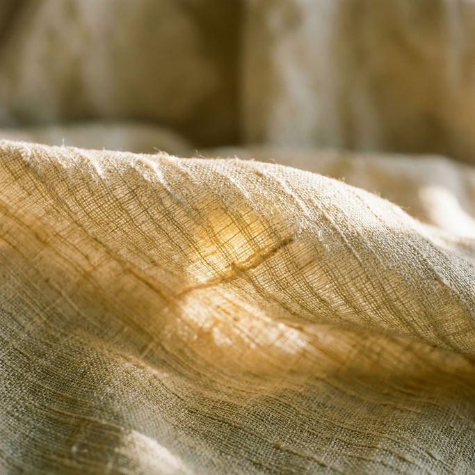 Extreme close-up of Raw silk fabric draped and catching side light (z4ylzeo4)