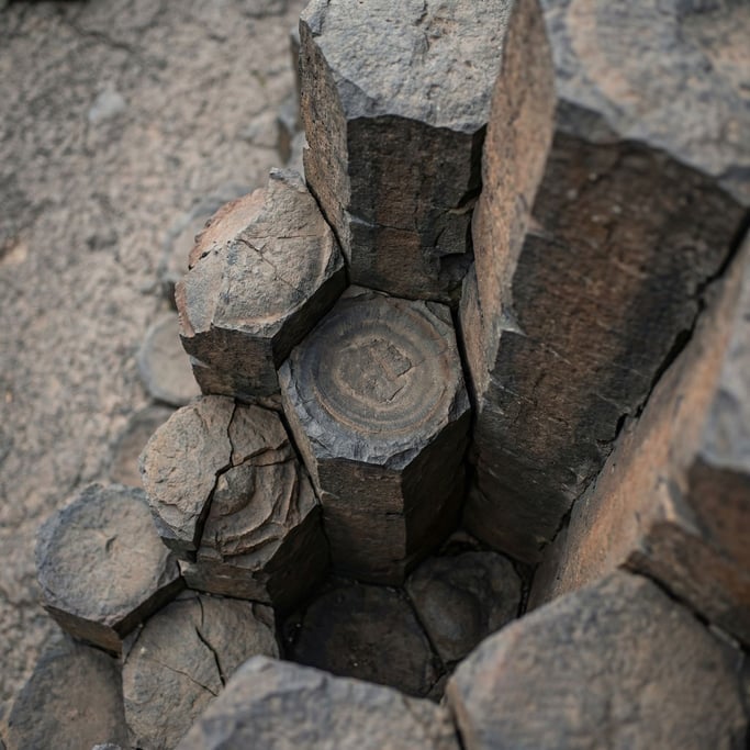 Volcanic basalt columns seen from above, hexagonal geometry formed by cooling lava (gsklie19)