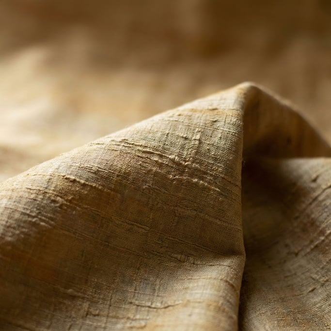 Detail photograph of Raw silk fabric draped and catching side light