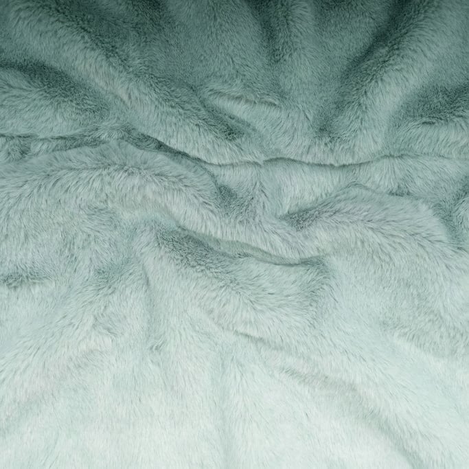 Seafoam-green dyed fur in short plush waves rippling horizontally through the composition