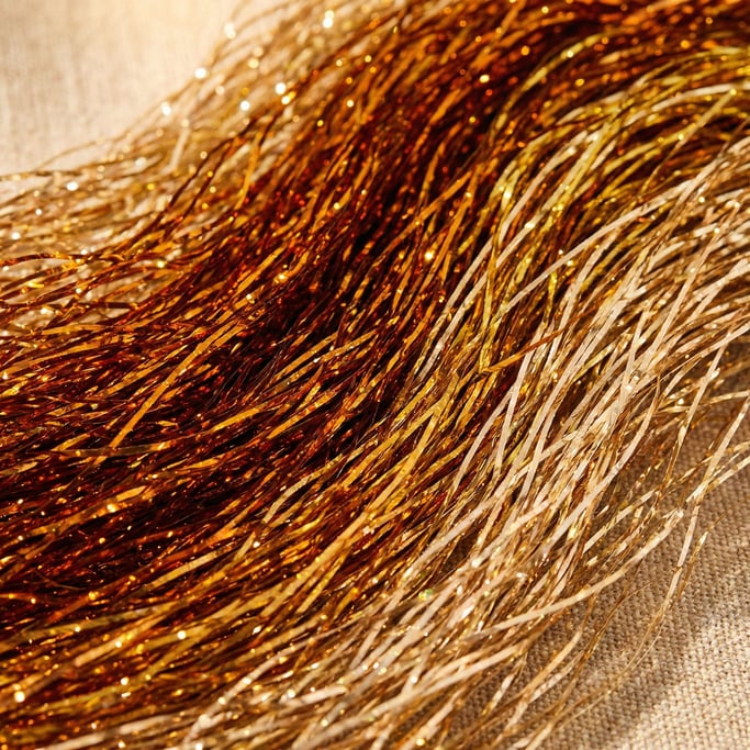 Amber-gold synthetic tinsel fur packed densely and with thousands of crimped metallic strands