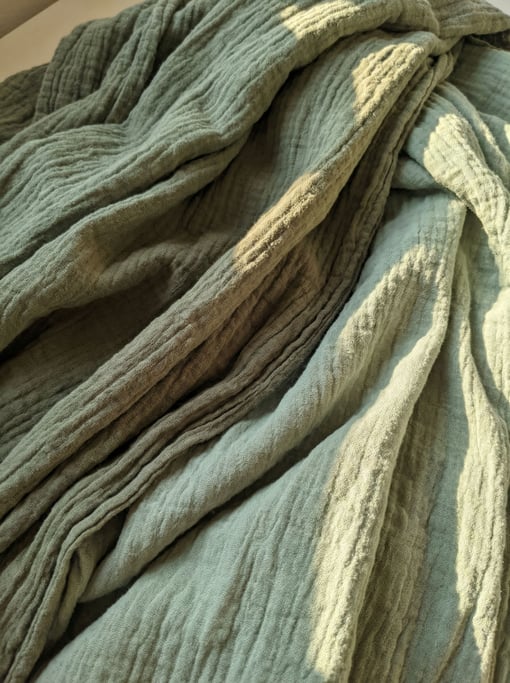 Sage-green cotton gauze in loose crinkled layers
