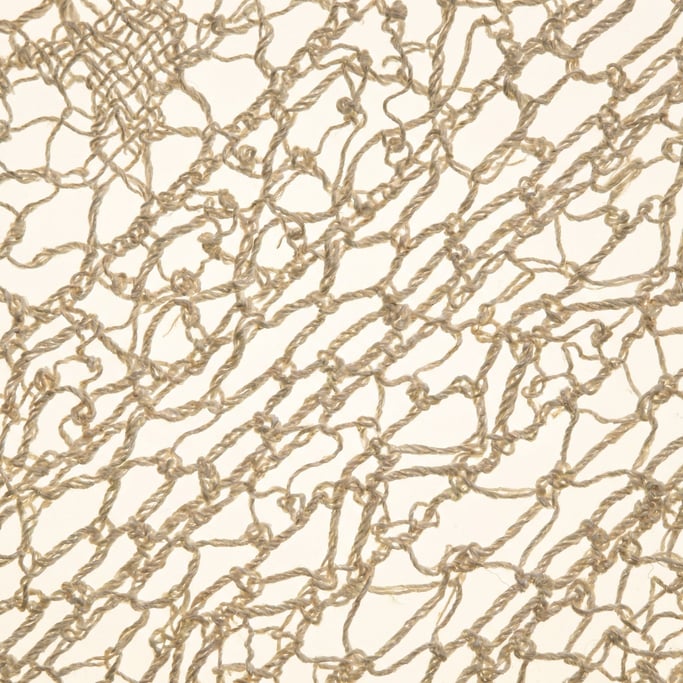 Bone-white lace at extreme macro showing the intricate bobbin-lace structure