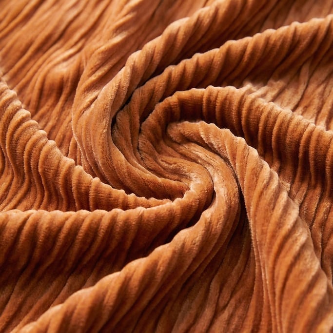 Apricot-toned silk velvet in gathered ruched folds creating deep dimensional channels across the composition