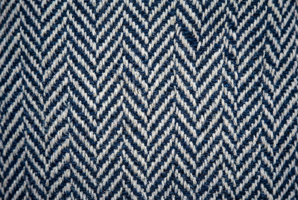 Navy-and-cream herringbone wool twill filling the frame