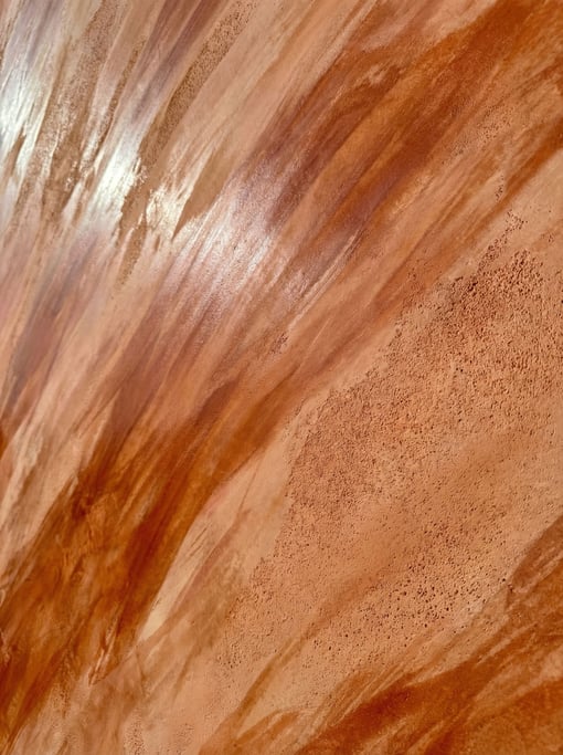 Venetian plaster pigmented in warm terracotta tones dominating the composition
