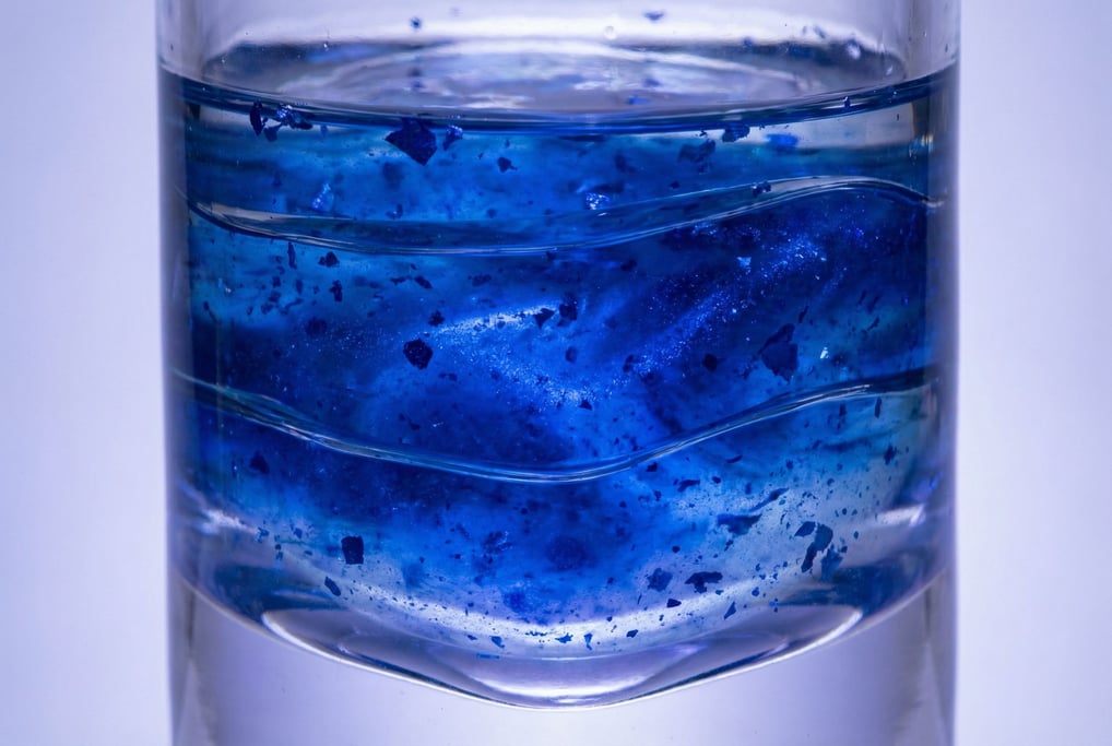 Ultramarine blue pigment suspended in clear resin filling the frame in thick transparent pours