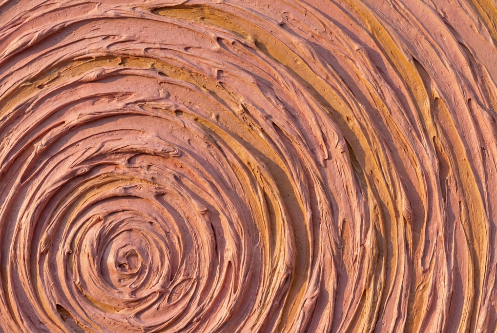 Flesh-toned oil paint in thick impasto sculpted into concentric ring patterns filling the frame