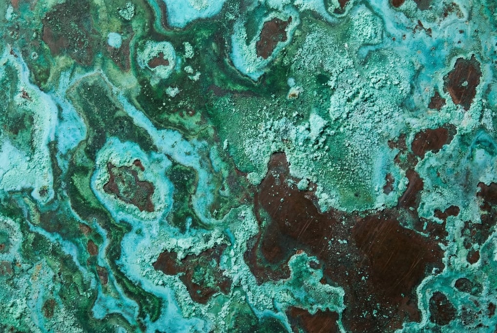 Heavily oxidized copper sheet filling the frame with its full verdigris patina