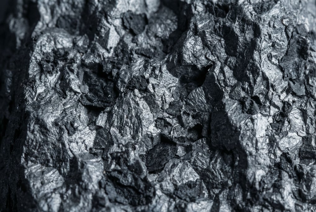 Cast iron in extreme close-up showing the granular crystalline structure filling the frame