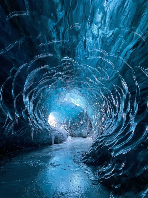 Glacier blue ice cave interior dominating the composition