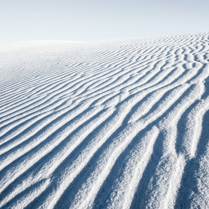 White gypsum sand dunes dominating the composition with brilliant white granules sculpted into ripple patterns by wind