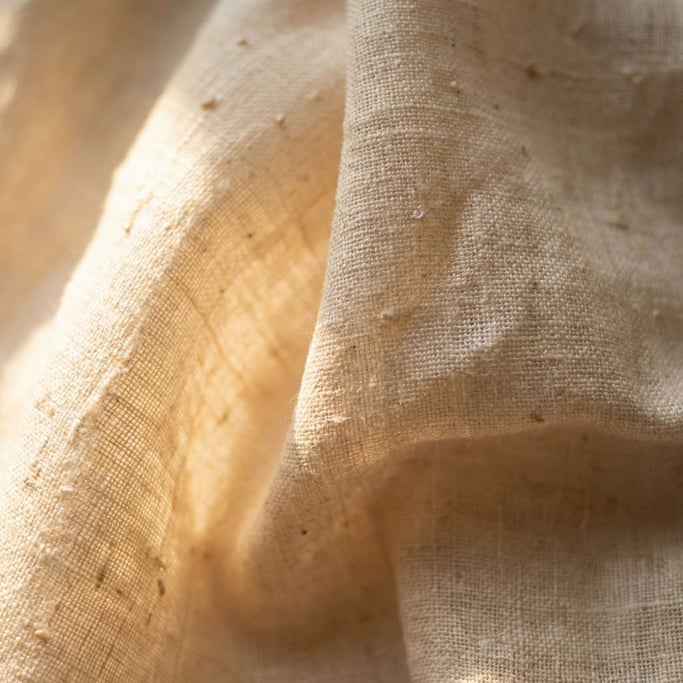 Extreme close-up of Raw silk fabric draped and catching side light (o78lm4)