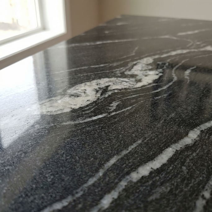 Extreme close-up of Polished dark granite with veins of white quartz running through, cool and heavy (zd388dxw)