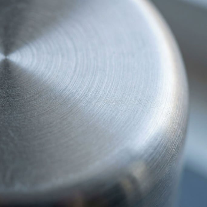 Extreme close-up of Brushed stainless steel with circular polishing marks, cool industrial surface (oaydgicj)