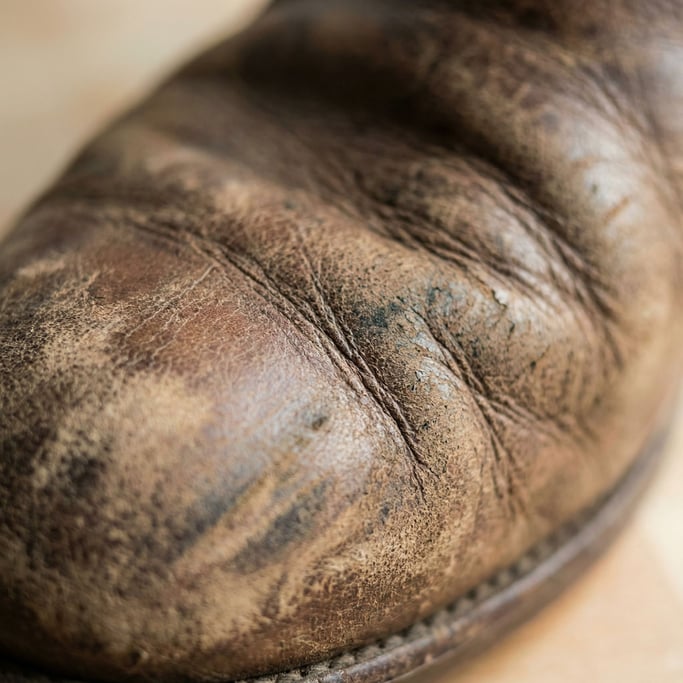 Extreme close-up of Worn leather surface showing natural grain, scratches (z)