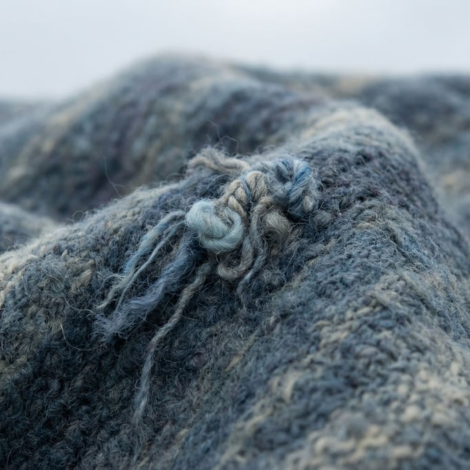 Felted wool surface, fibers interlocked and matted, soft undulating hills in macro (bk0dbvup)