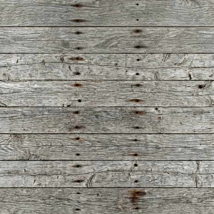 Seamless tileable texture of reclaimed barn wood, weathered grey barn wood with nail holes