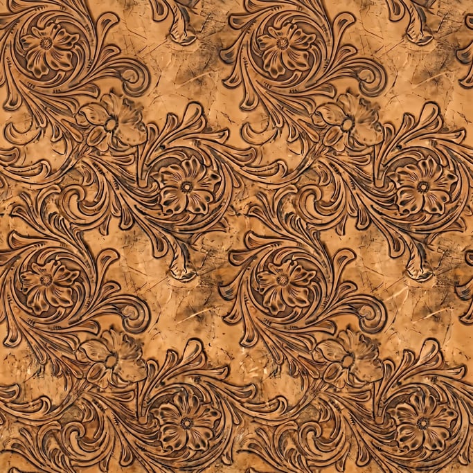 Seamless tileable texture of tooled leather heavily worn and patinated