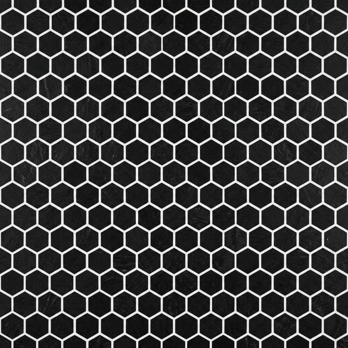 Seamless tileable texture of hexagonal tile in black freshly cut and raw