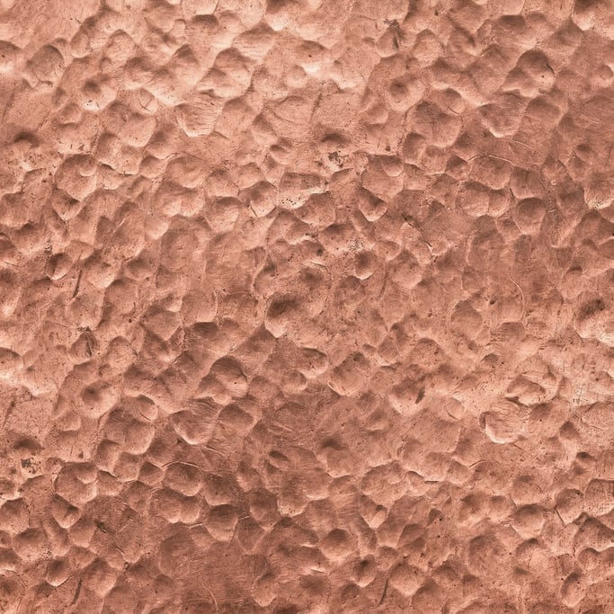 Seamless tileable texture of hammered copper in extreme close-up showing micro-detail