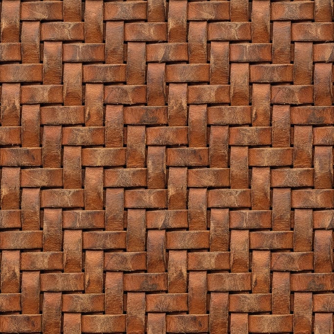 Seamless tileable texture of woven leather strips heavily worn and patinated