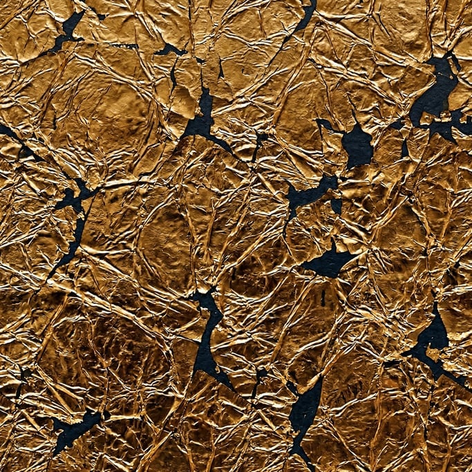 Seamless tileable texture of gold leaf wet with water